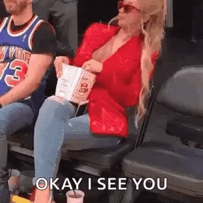 Woman Sitting In Stadium With Popcorn And Soda GIF