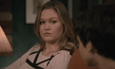 Woman Sitting Next To Man On Couch Looking At Camera GIF