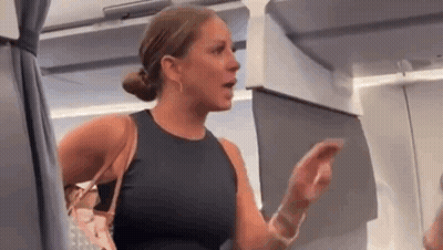 Woman Sitting On Airplane Talking To Another Woman Holding Purse GIF