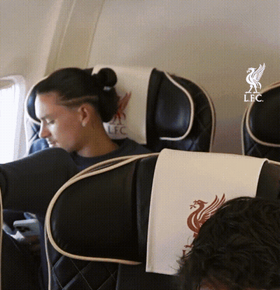 Woman Sitting On Airplane With LFC Logo GIF