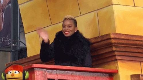 Woman Sitting On Balcony With Sesame Street Puppet GIF
