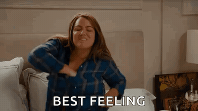 Woman Sitting On Bed Hands On Chest Saying Best Feeling GIF