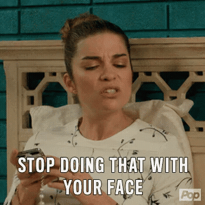 Woman Sitting On Bed Holding Cell Phone Making Face GIF