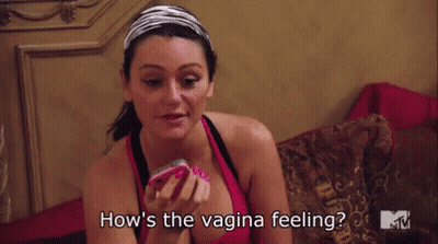 Woman Sitting On Bed Holding Cell Phone Saying How's The Vagina Feeling GIF