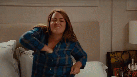Woman Sitting On Bed In Blue Plaid Shirt GIF