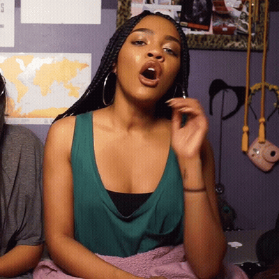Woman Sitting On Bed With Open Mouth GIF
