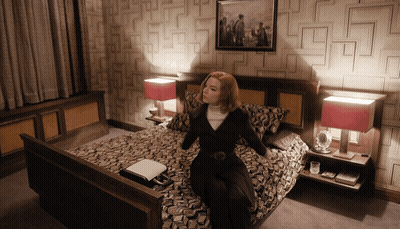Woman Sitting On Bed With Picture Above GIF