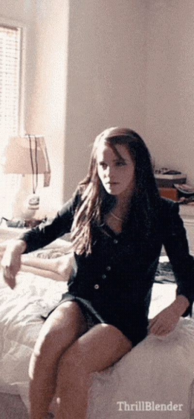 Woman Sitting On Bed With Thrillblender Text GIF