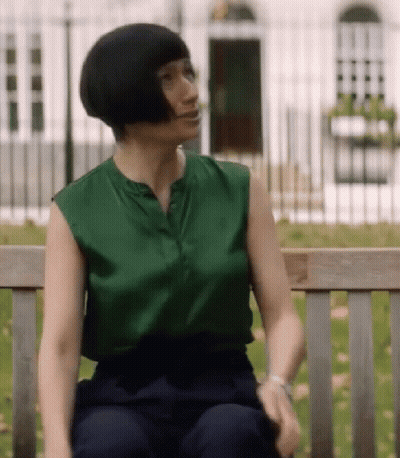 Woman Sitting On Bench Green Top Blue Pants GIF