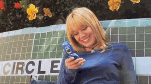 Woman Sitting On Bench Holding Cell Phone GIF