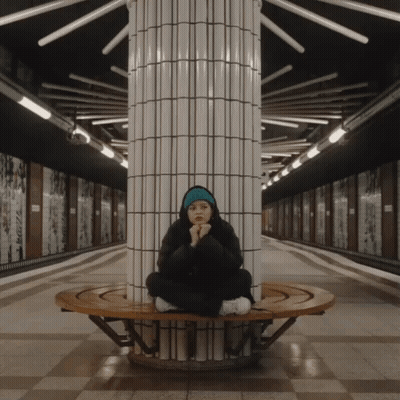 Woman Sitting On Bench In Subway Station GIF
