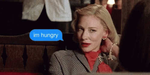 Woman Sitting On Bench Says Im Hungry GIF