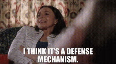 Woman Sitting On Couch Arms Crossed Smiling GIF