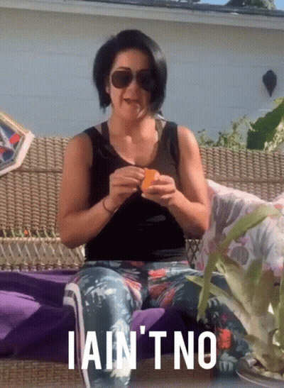Woman Sitting On Couch Eating Orange Saying I Ain't No GIF