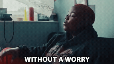 Woman Sitting On Couch Eyes Closed Without A Worry GIF