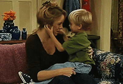 Woman Sitting On Couch Holding Child GIF