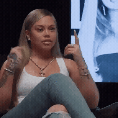 Woman Sitting on Couch Holding Microphone