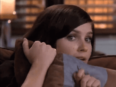 Woman Sitting On Couch Holding Paper GIF