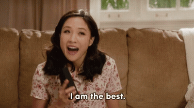 Woman Sitting On Couch Holding Remote Saying I Am The Best GIF