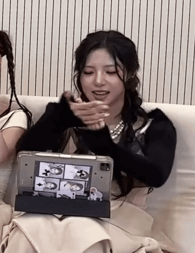 Woman Sitting On Couch Holding Tablet Making Funny Face GIF