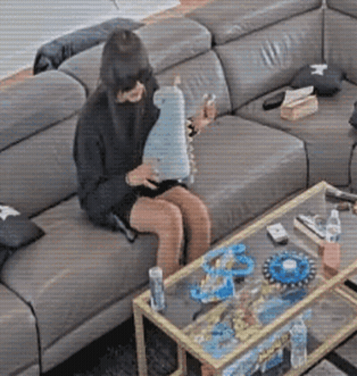 Woman Sitting On Couch Holding Toy GIF