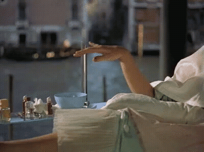 Woman Sitting On Couch Holding Water GIF