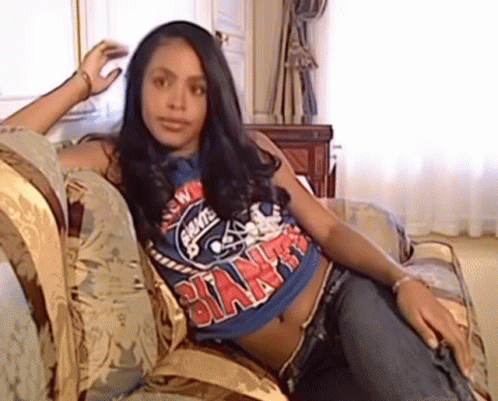 Woman Sitting on Couch in Blue Giants Shirt