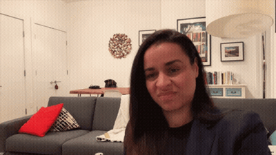 Woman Sitting On Couch In Living Room GIF