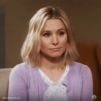 Woman Sitting on Couch in Purple Cardigan Making Funny Face