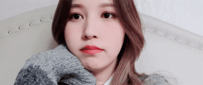 Woman Sitting On Couch In Sweater GIF