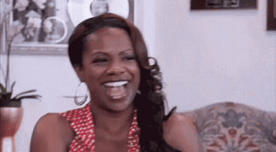 Woman Sitting On Couch Laughing GIF