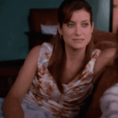 Woman Sitting On Couch Looking At Camera GIF