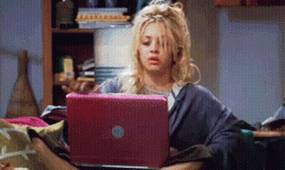 Woman Sitting On Couch Looking At Laptop GIF