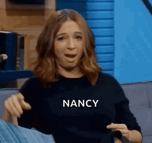 Woman Sitting On Couch Making Funny Face GIF