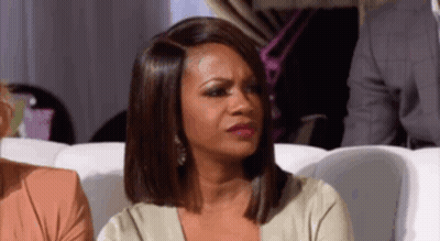 Woman Sitting On Couch Making Funny Face GIF