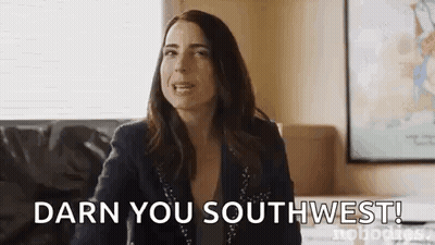 Woman Sitting On Couch Making Funny Face GIF