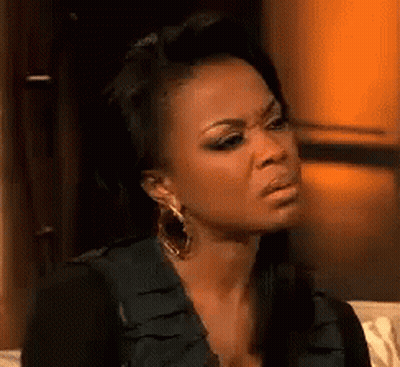 Woman Sitting On Couch Making Funny Face GIF