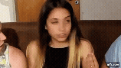 Woman Sitting On Couch Making Funny Face GIF