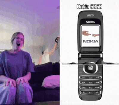Woman Sitting On Couch Next To Nokia Phone GIF