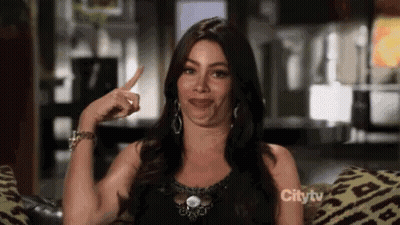 Woman Sitting On Couch Pointing GIF