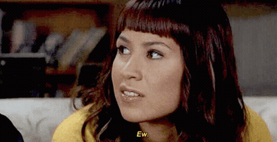 Woman Sitting On Couch Saying Ew GIF