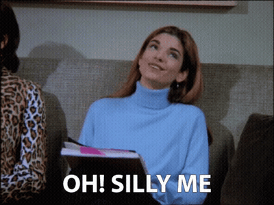 Woman Sitting On Couch Saying Oh Silly Me GIF