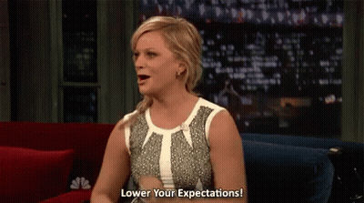 Woman Sitting On Couch Says Lower Your Expectations GIF