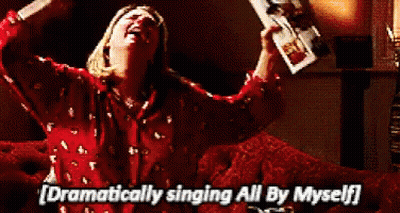 Woman Sitting On Couch Singing Holding Beer GIF