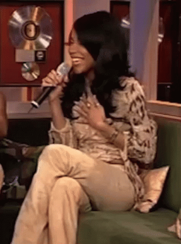 Woman Sitting On Couch Singing Into Microphone GIF