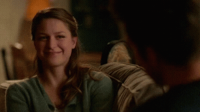 Woman Sitting On Couch Smiling At Man GIF