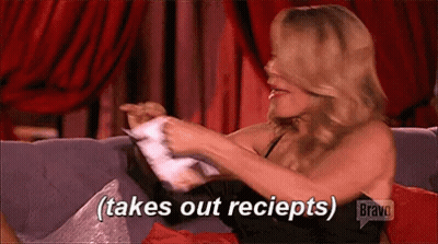 Woman Sitting On Couch Takes Out Receipts GIF