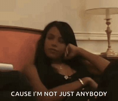 Woman Sitting On Couch Talking On Cell Phone GIF