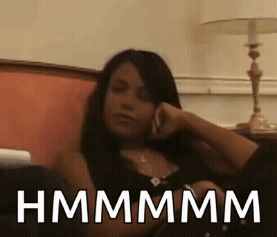 Woman Sitting On Couch Talking On Cell Phone Hmmmm GIF