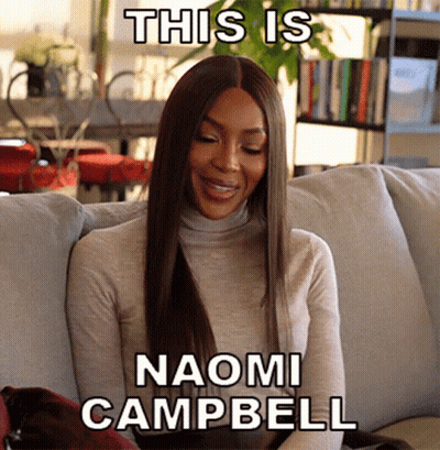 Woman Sitting On Couch This Is Naomi Campbell GIF